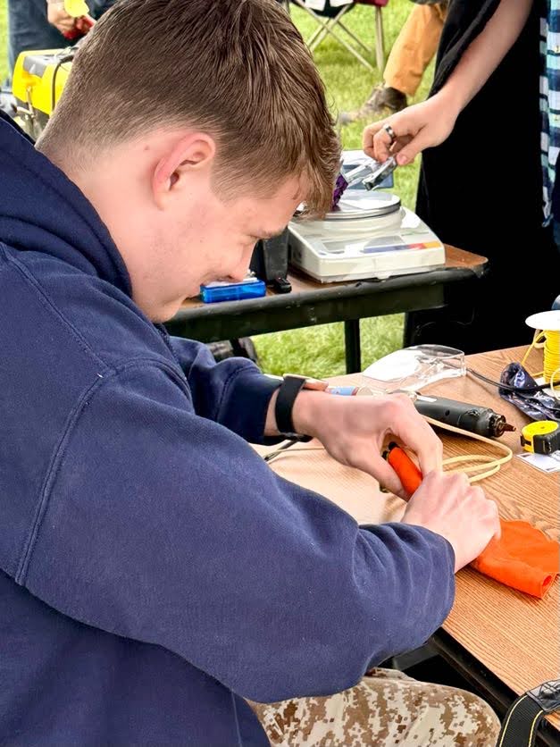 Rocket club members packing the competition rocket before launch